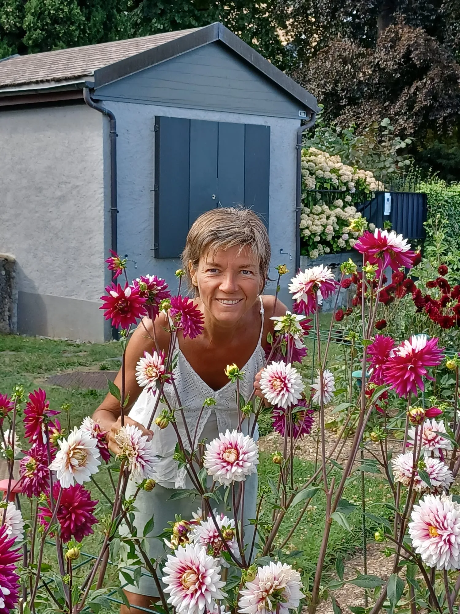 Nadia, practitioner at Le Petit Coin Massages, in her garden in Morges